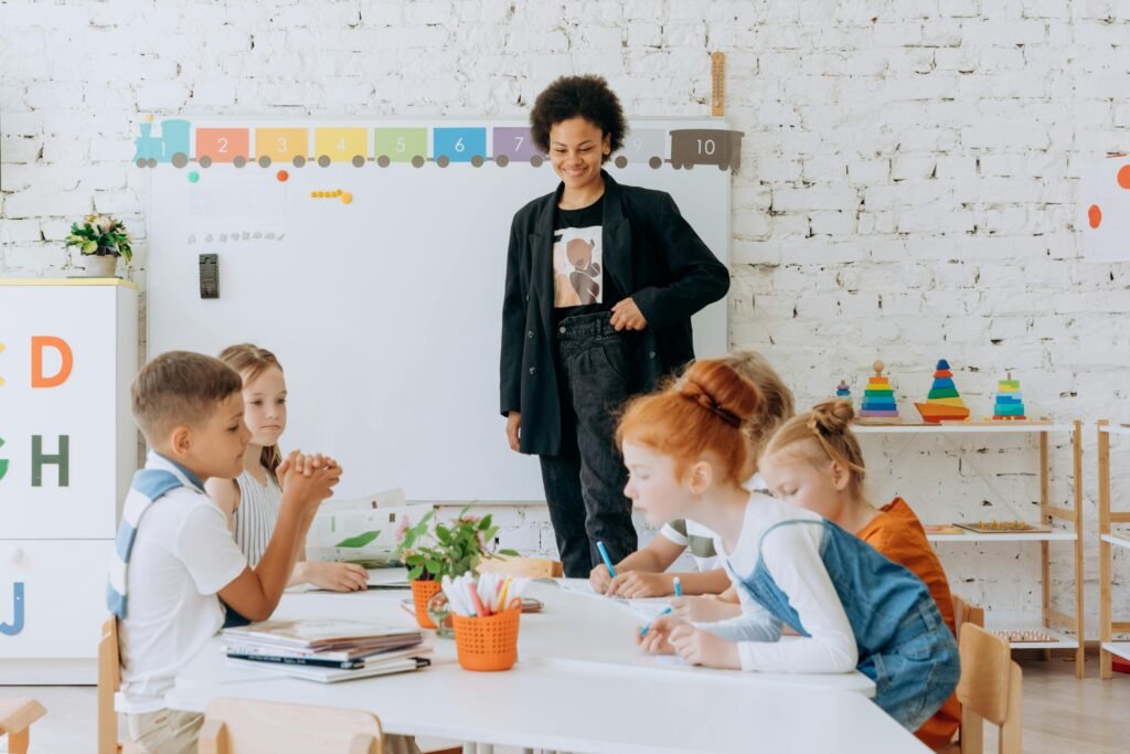 Children engaged in educational activities with teacher in a colorful classroom setting.